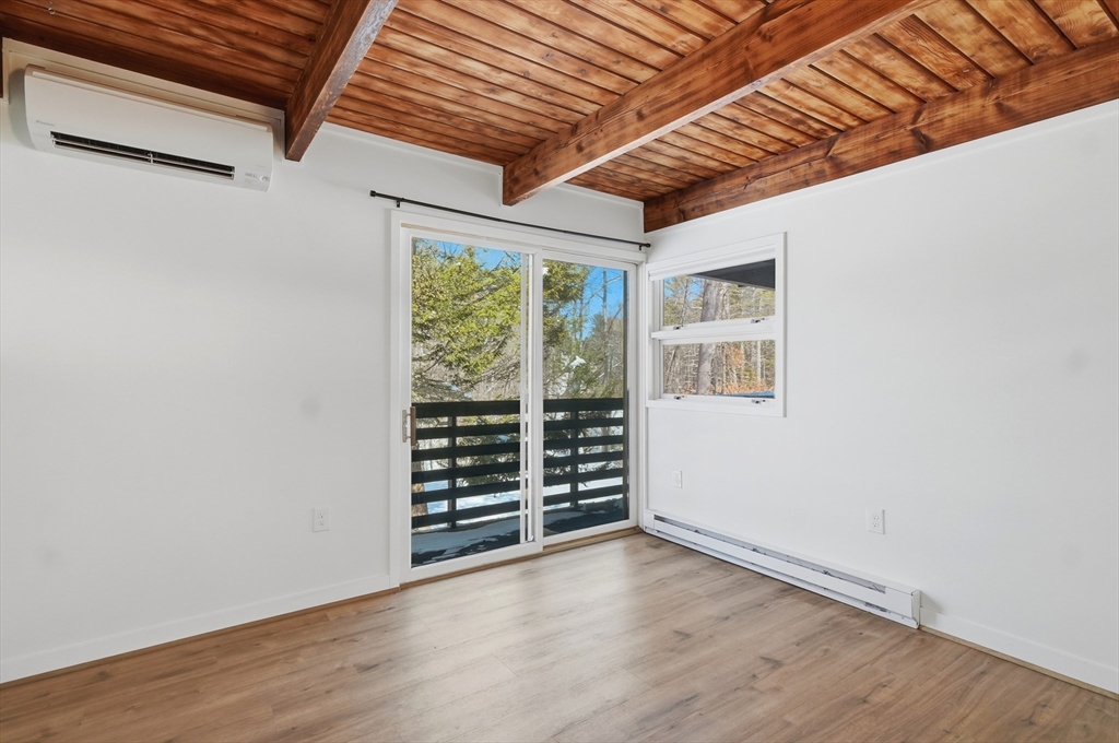 1081 Lowell Road Groton, MA 01450 - Photo 29 of 42 an empty room with wooden floor and windows