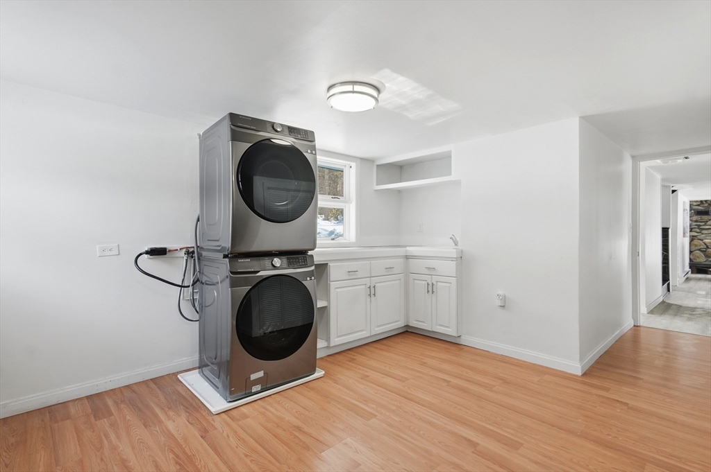 1081 Lowell Road Groton, MA 01450 - Photo 32 of 42 a view of a storage & utility room with wooden floor