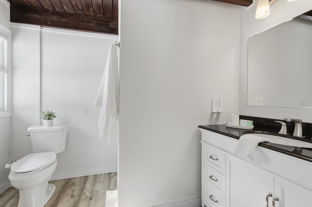1081 Lowell Road Groton, MA 01450 - Photo 33 of 42 a bathroom with a granite countertop sink toilet and shower
