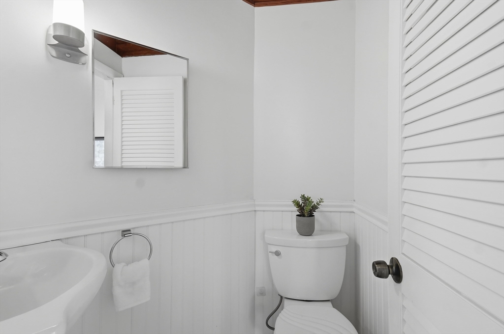 1081 Lowell Road Groton, MA 01450 - Photo 34 of 42 a bathroom with a toilet sink and mirror