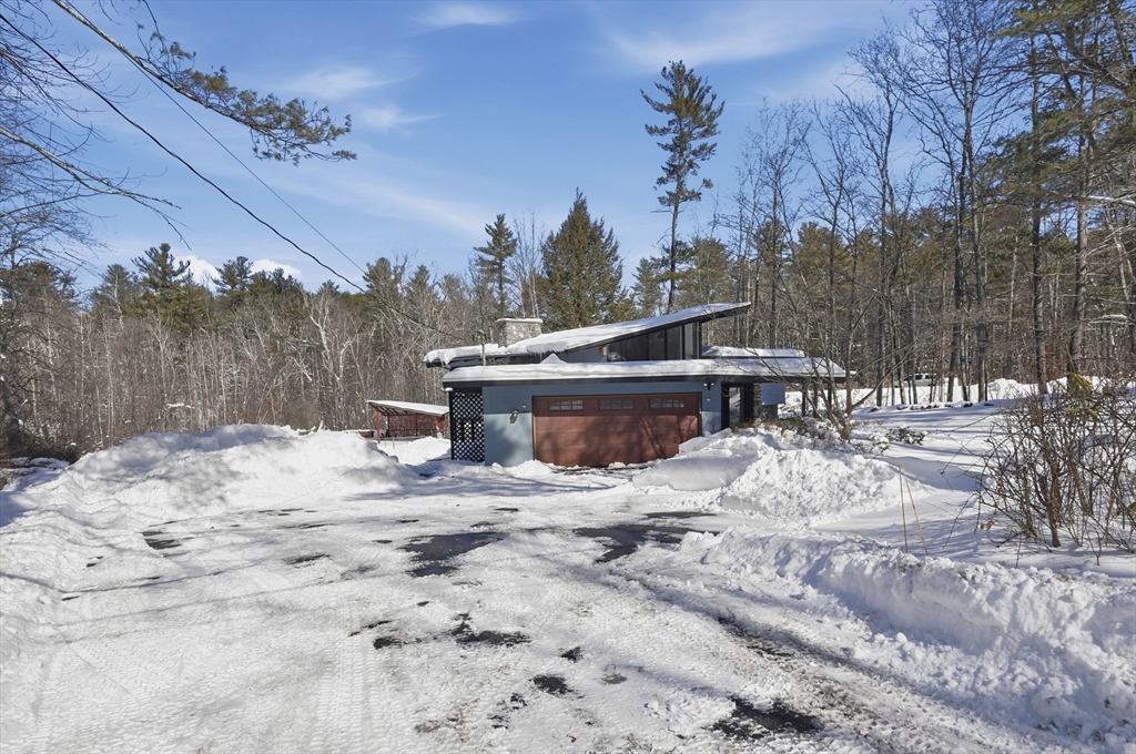 1081 Lowell Road Groton, MA 01450 - Photo 35 of 42 a view of a backyard with a snow on the road