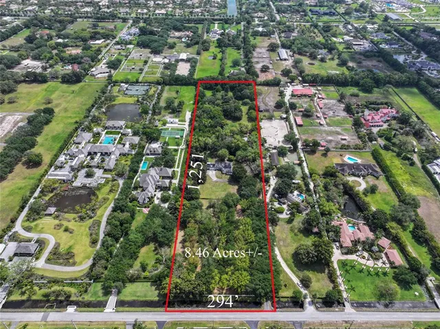 an aerial view of residential houses with outdoor space and street view
