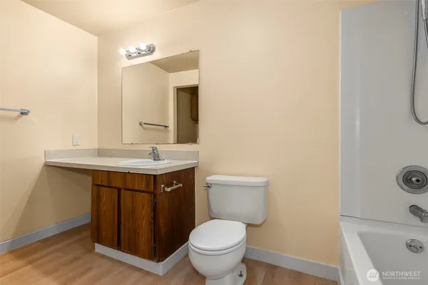 a bathroom with a toilet sink and mirror