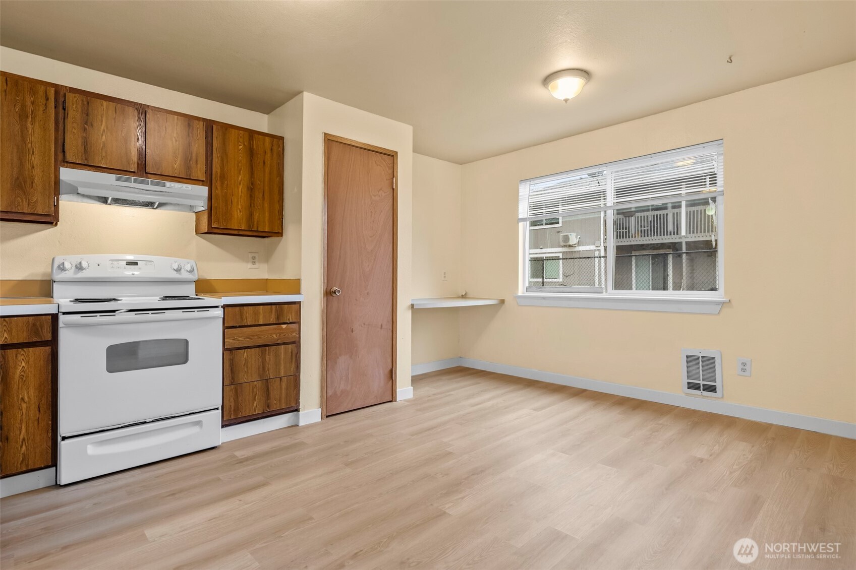 15912 Elm Street East Sumner, WA 98390 - Photo 2 of 30 a kitchen with a stove microwave and cabinets