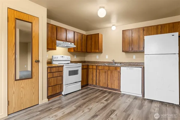 a kitchen with white cabinets and white appliances