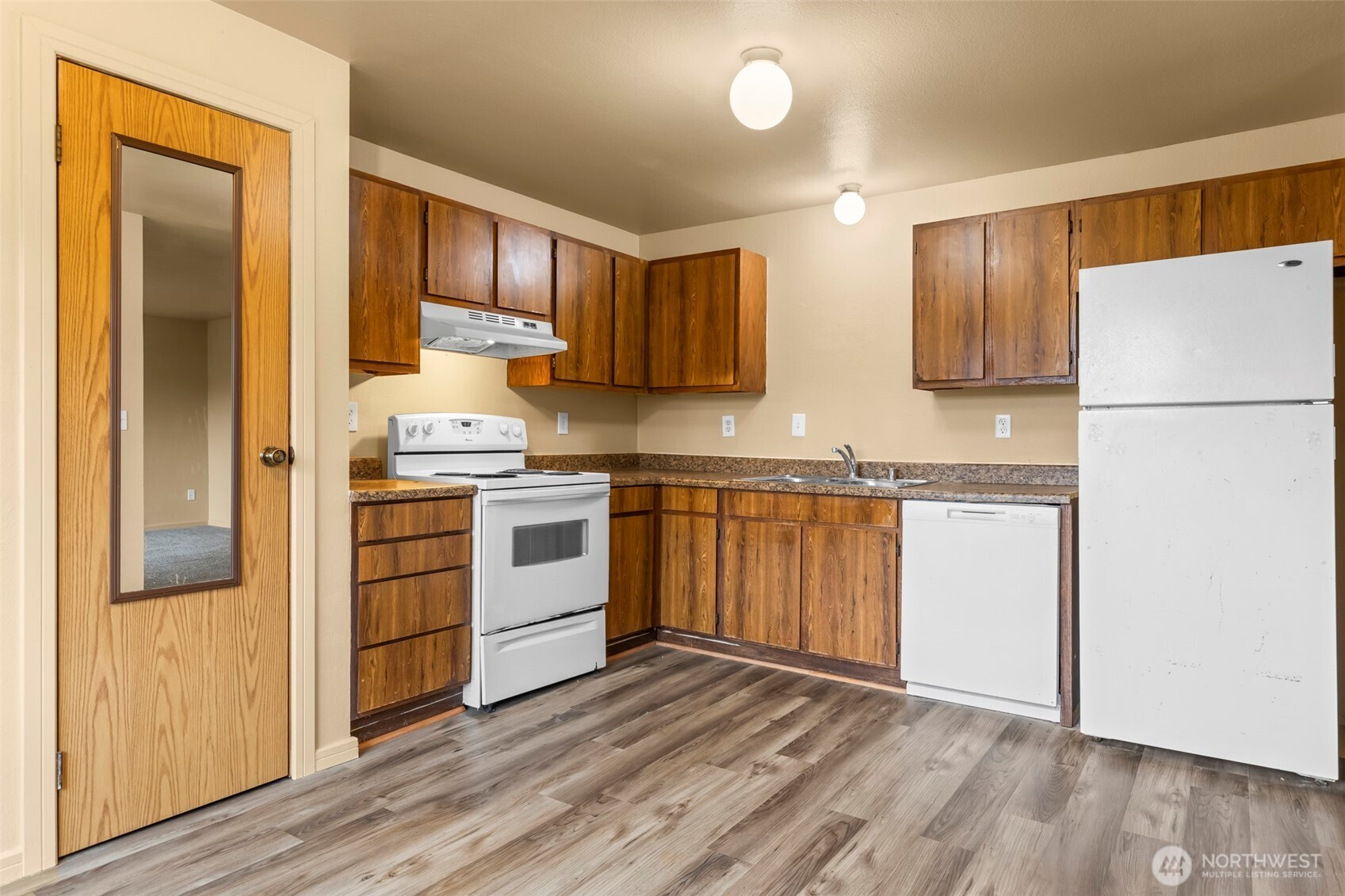 15912 Elm Street East Sumner, WA 98390 - Photo 3 of 30 a kitchen with white cabinets and white appliances
