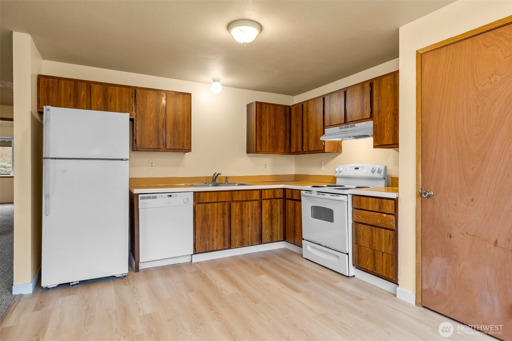 15912 Elm Street East Sumner, WA 98390 - Photo 5 of 30 a kitchen with stainless steel appliances a refrigerator sink and cabinets