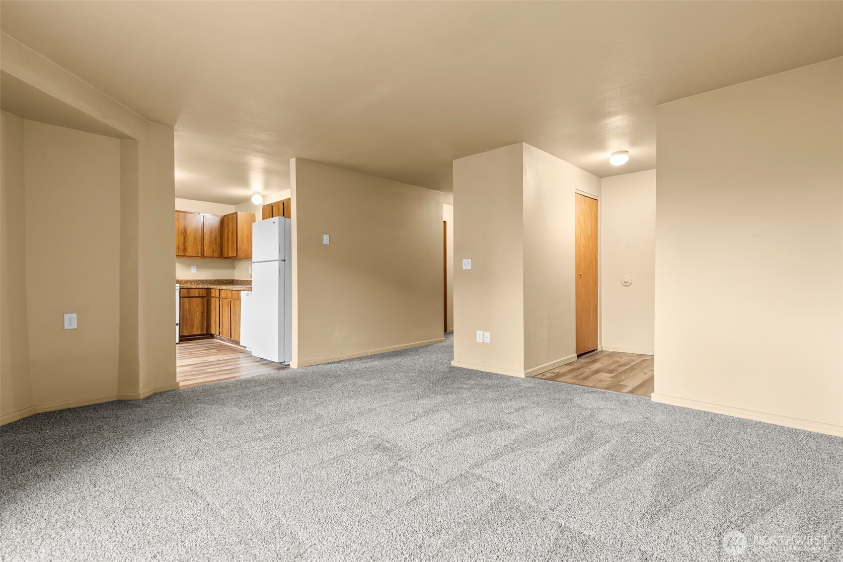 15912 Elm Street East Sumner, WA 98390 - Photo 6 of 30 a view of an empty room with a kitchen