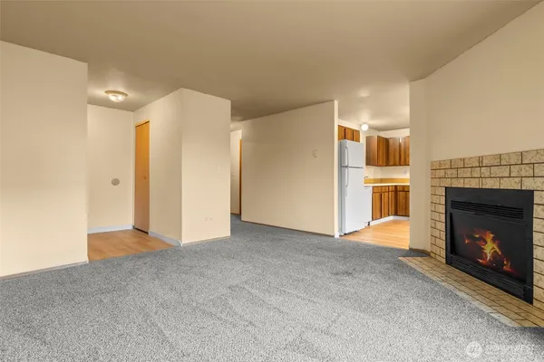 a view of an empty room with a fireplace