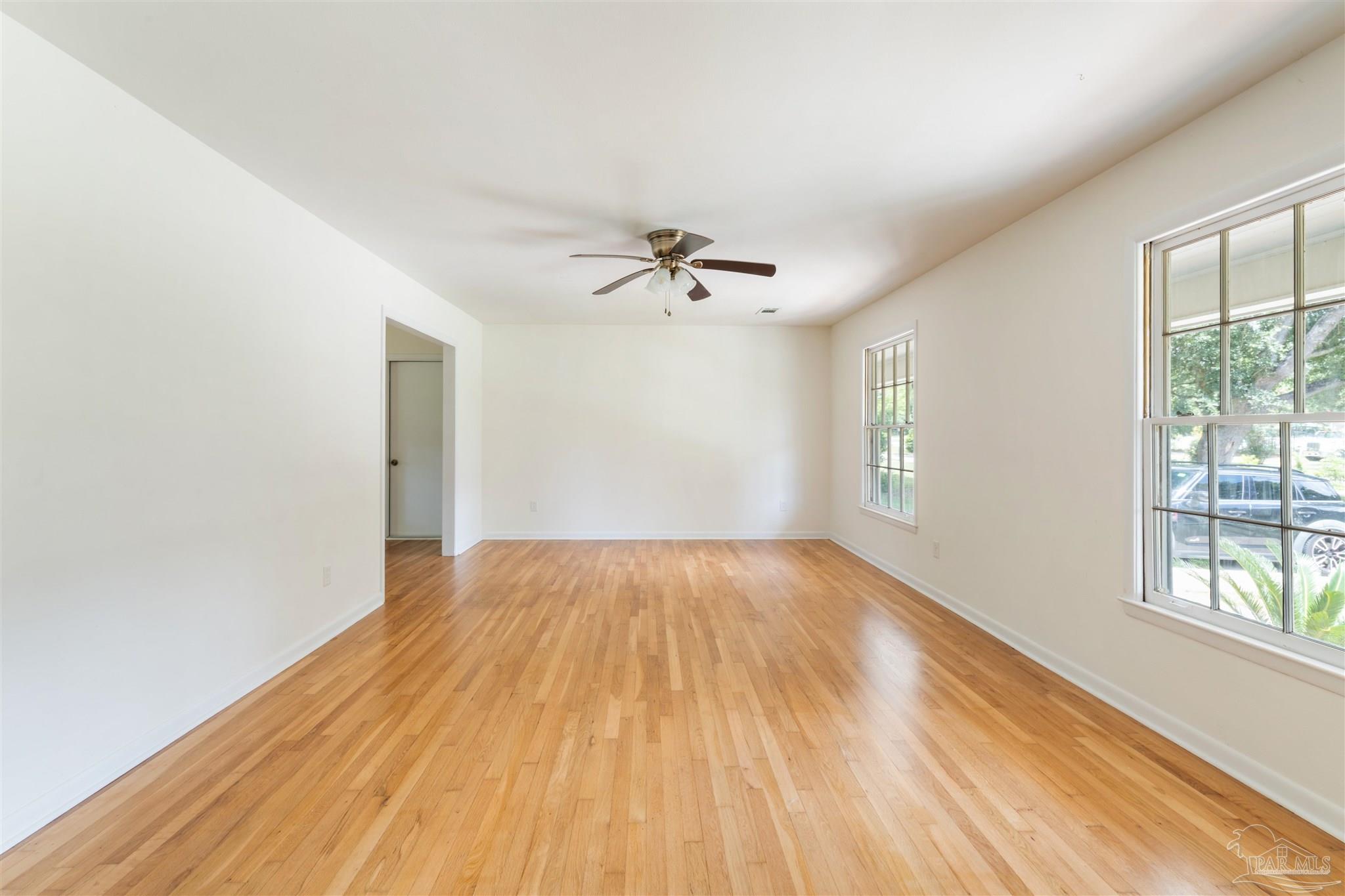 2045 Summit Boulevard Pensacola, FL 32503 - Photo 3 of 23 wooden floor in an empty room with a window