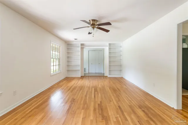 wooden floor in an empty room with a window