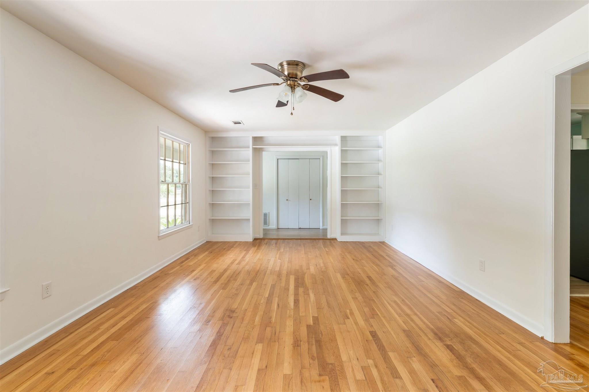 2045 Summit Boulevard Pensacola, FL 32503 - Photo 4 of 23 wooden floor in an empty room with a window