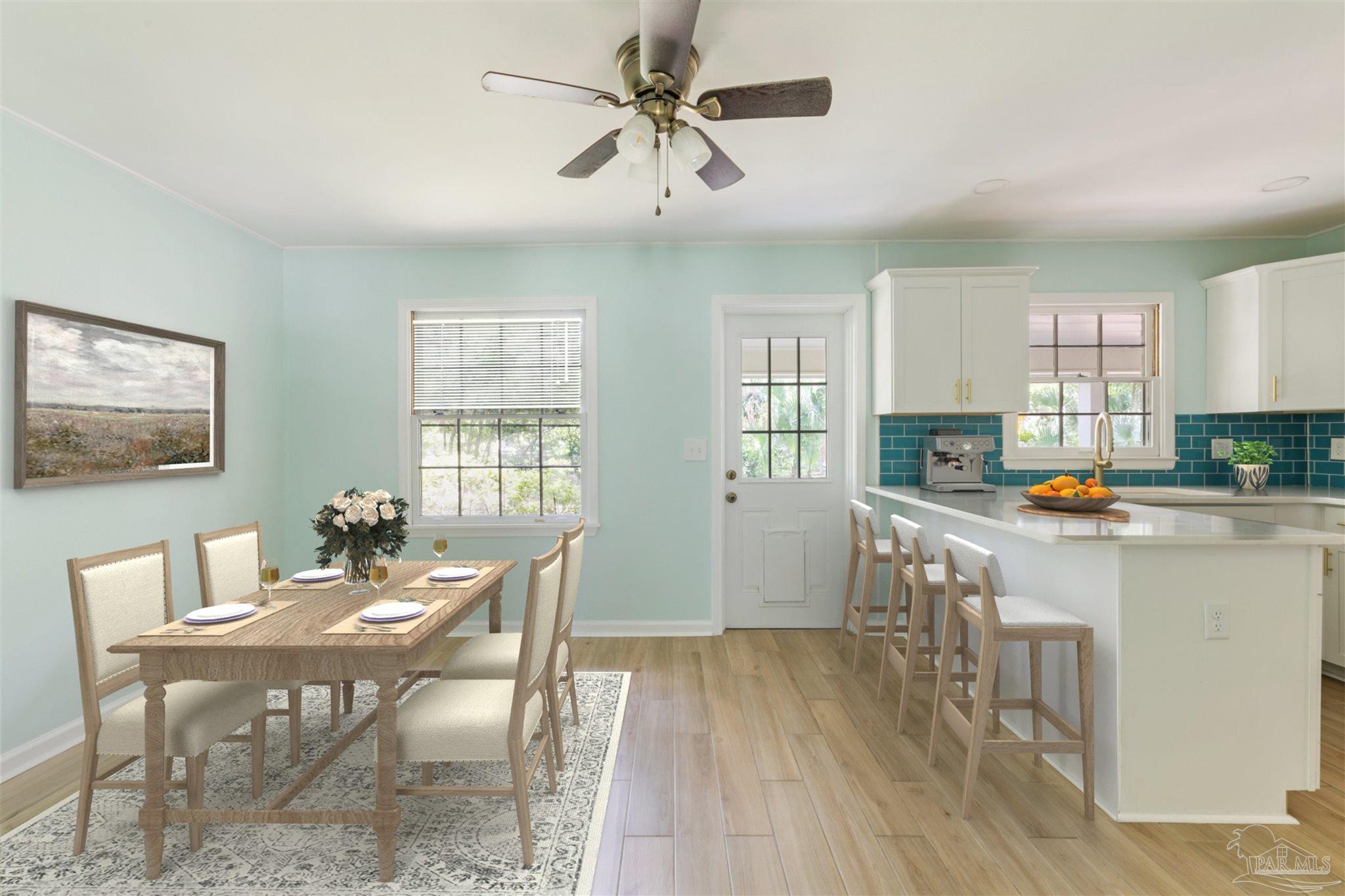 2045 Summit Boulevard Pensacola, FL 32503 - Photo 7 of 23 a kitchen with granite countertop a stove a sink a dining table and chairs with wooden floor