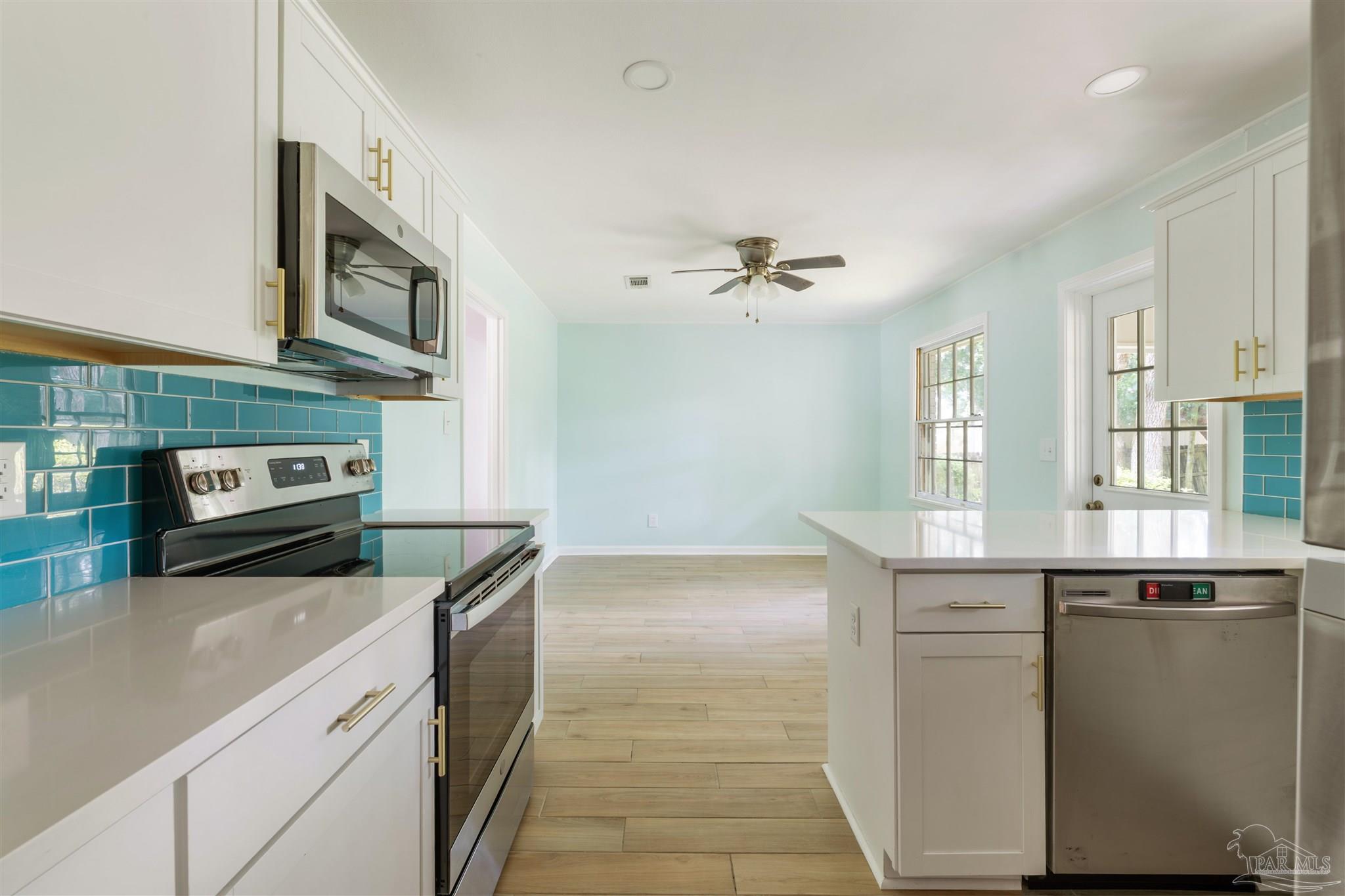 2045 Summit Boulevard Pensacola, FL 32503 - Photo 8 of 23 a kitchen with stainless steel appliances granite countertop a sink and stove