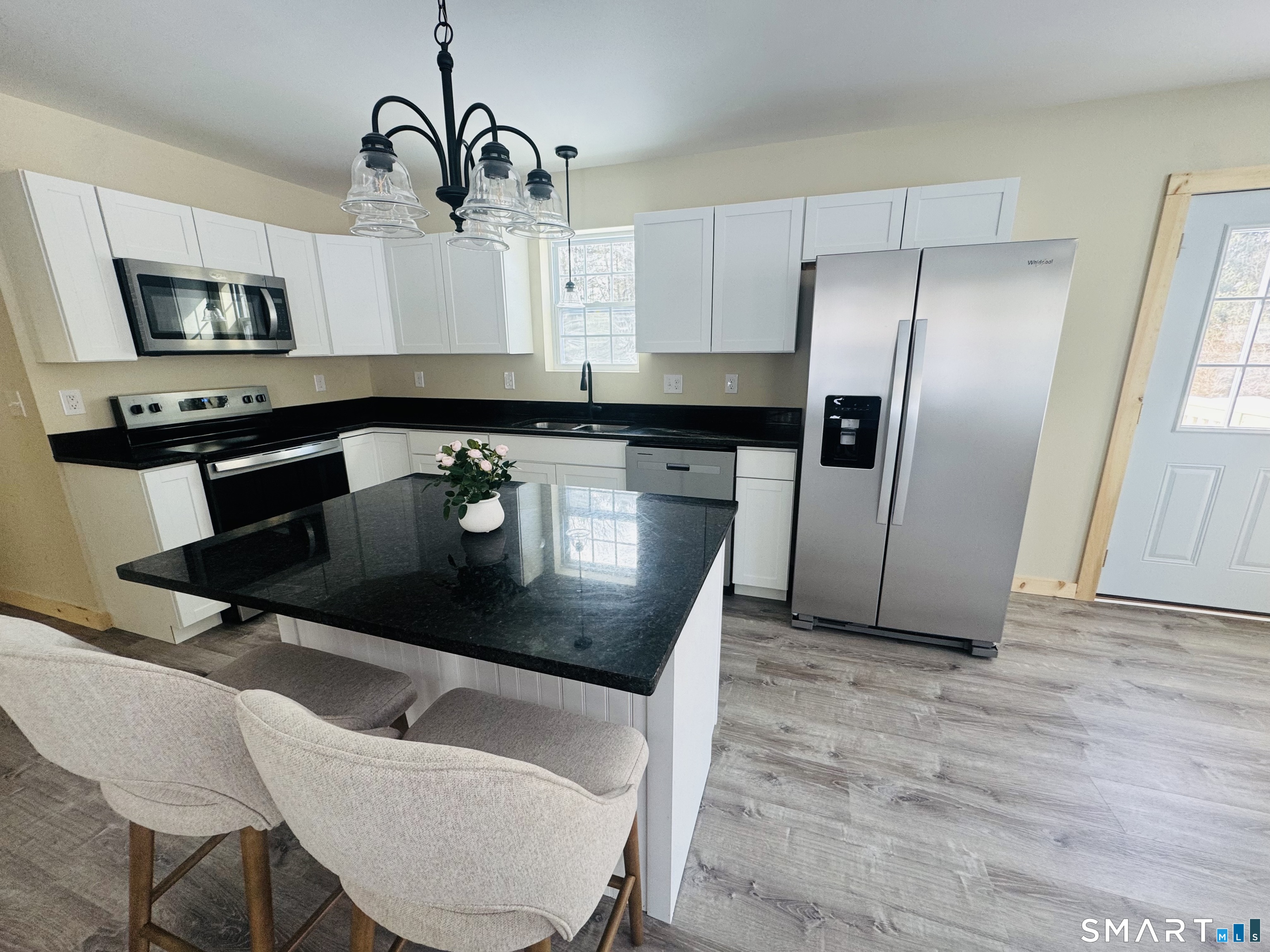 199 Main Street Sterling, CT 06377 - Photo 1 of 1 a kitchen with stainless steel appliances granite countertop a sink a microwave and a refrigerator
