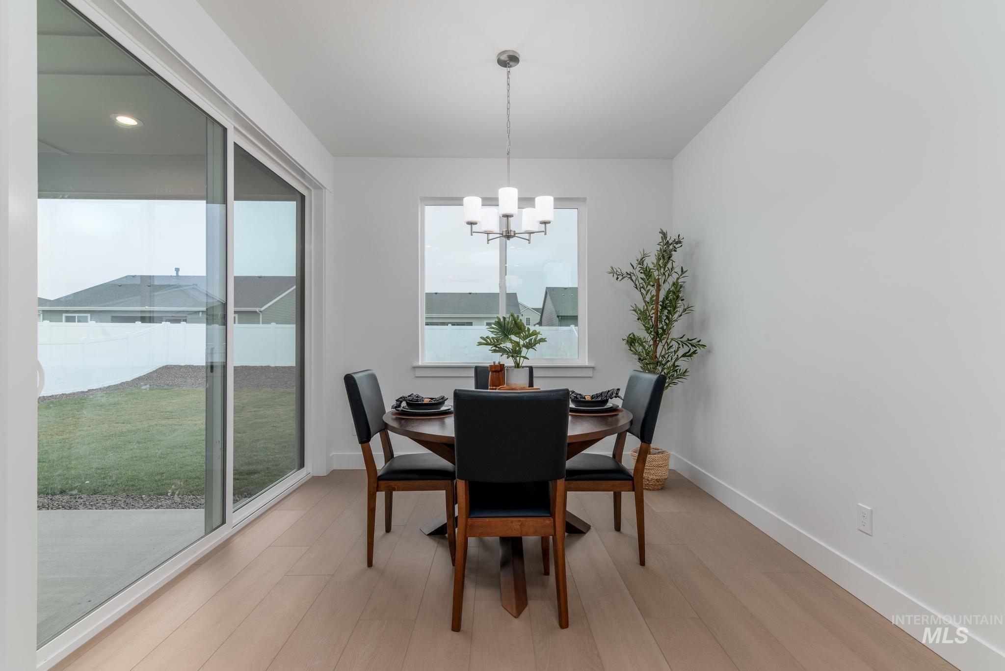 1907 West Blue Lightning Street Middleton, ID 83644 - Photo 6 of 11 Dining room with light wood finished floors and a chandelier