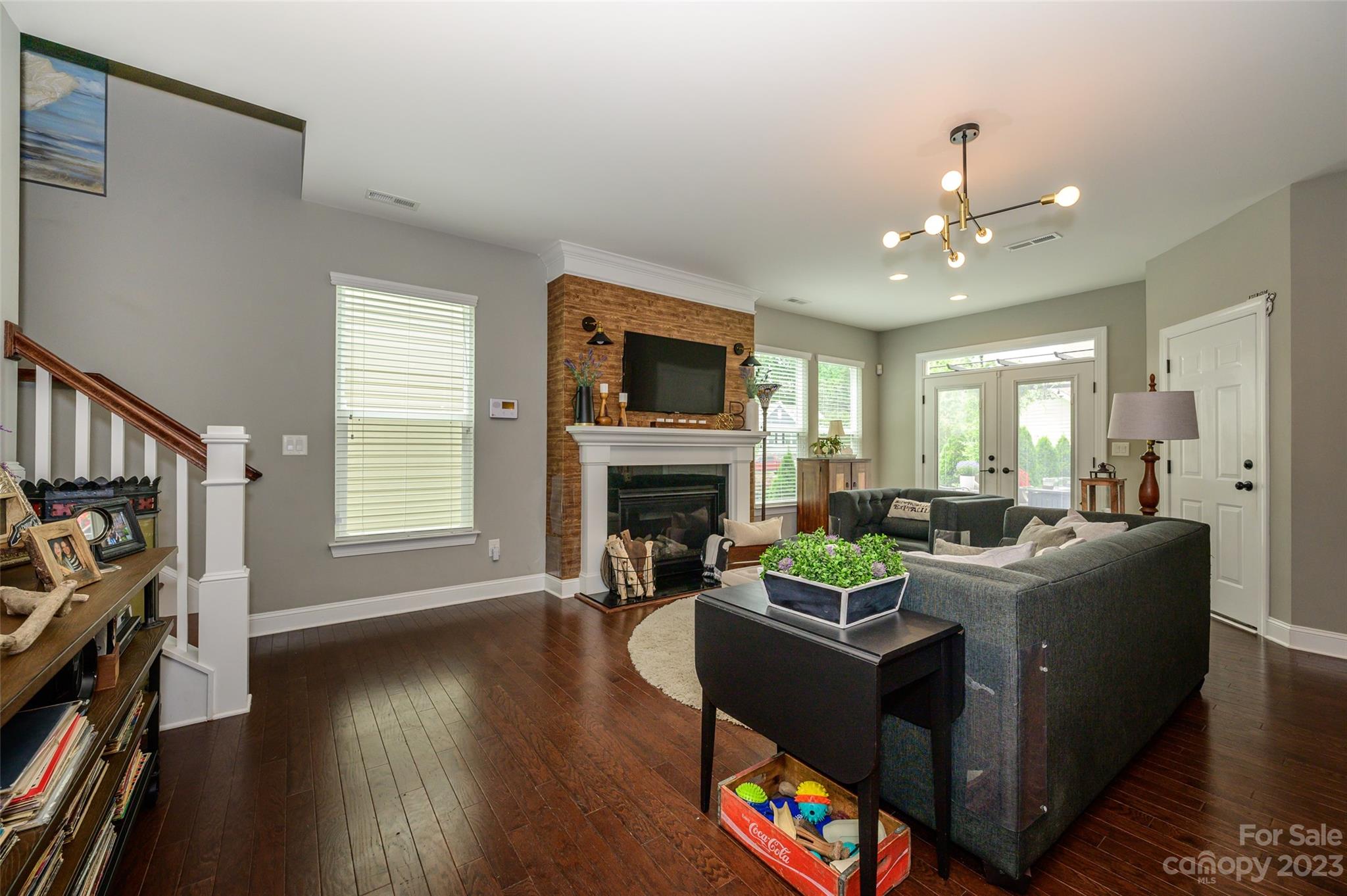3317 Lucy Drive Monroe, NC 28110 - Photo 11 of 38 a living room with furniture a fireplace and a flat screen tv