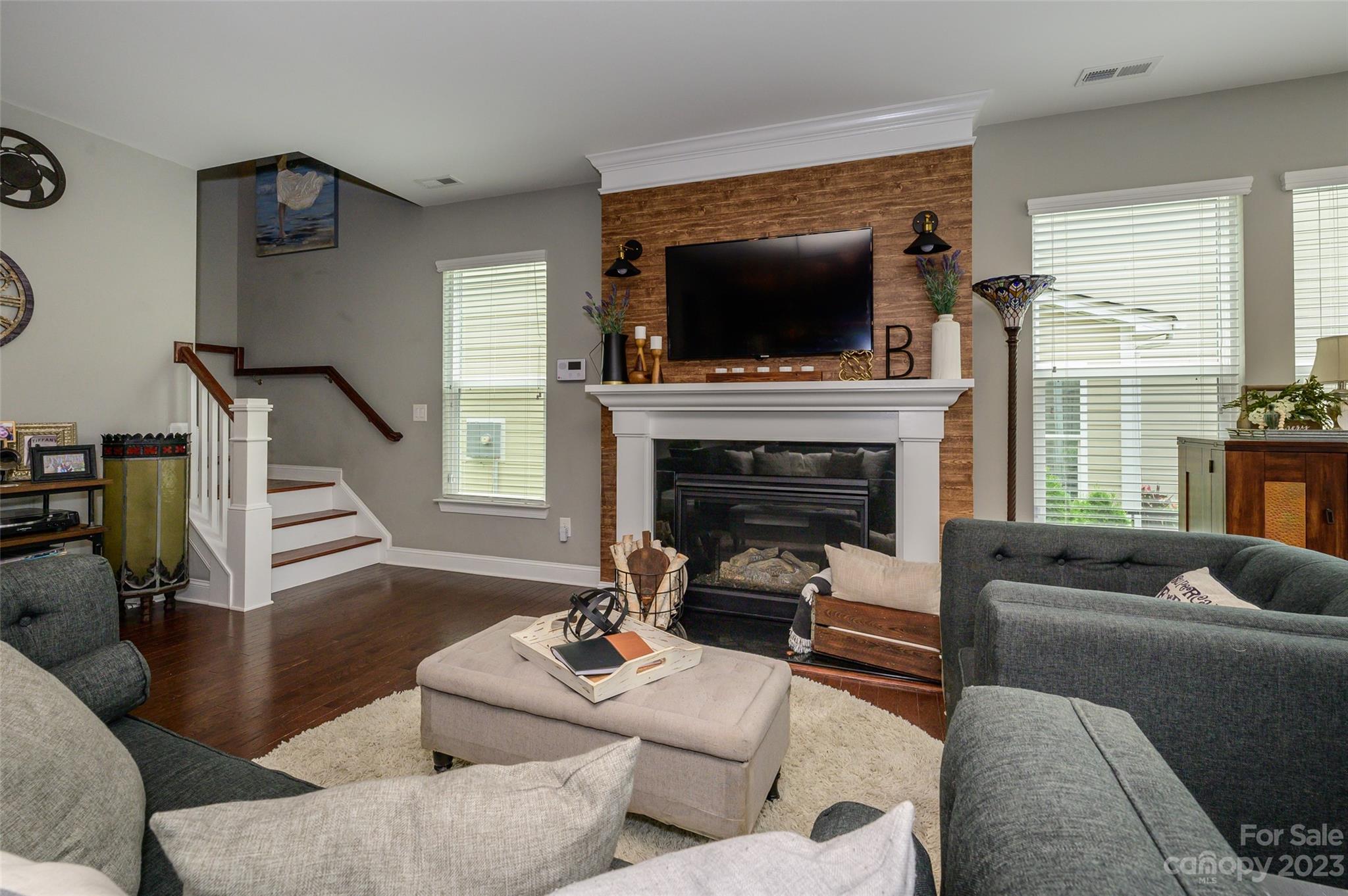 3317 Lucy Drive Monroe, NC 28110 - Photo 12 of 38 a living room with furniture a flat screen tv and a fireplace