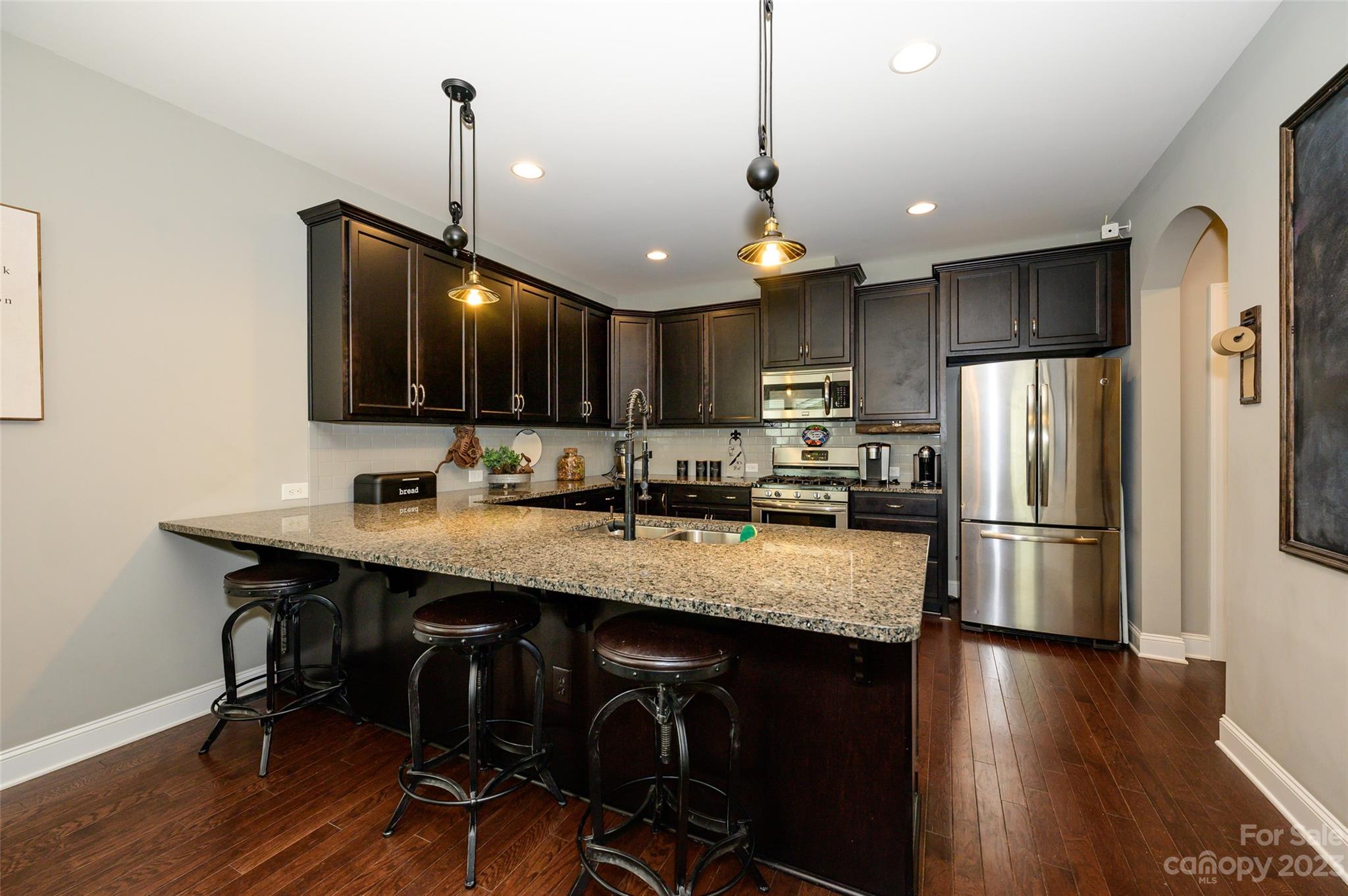 3317 Lucy Drive Monroe, NC 28110 - Photo 15 of 38 a kitchen with stainless steel appliances granite countertop a refrigerator a sink dishwasher a stove and a refrigerator with wooden floor