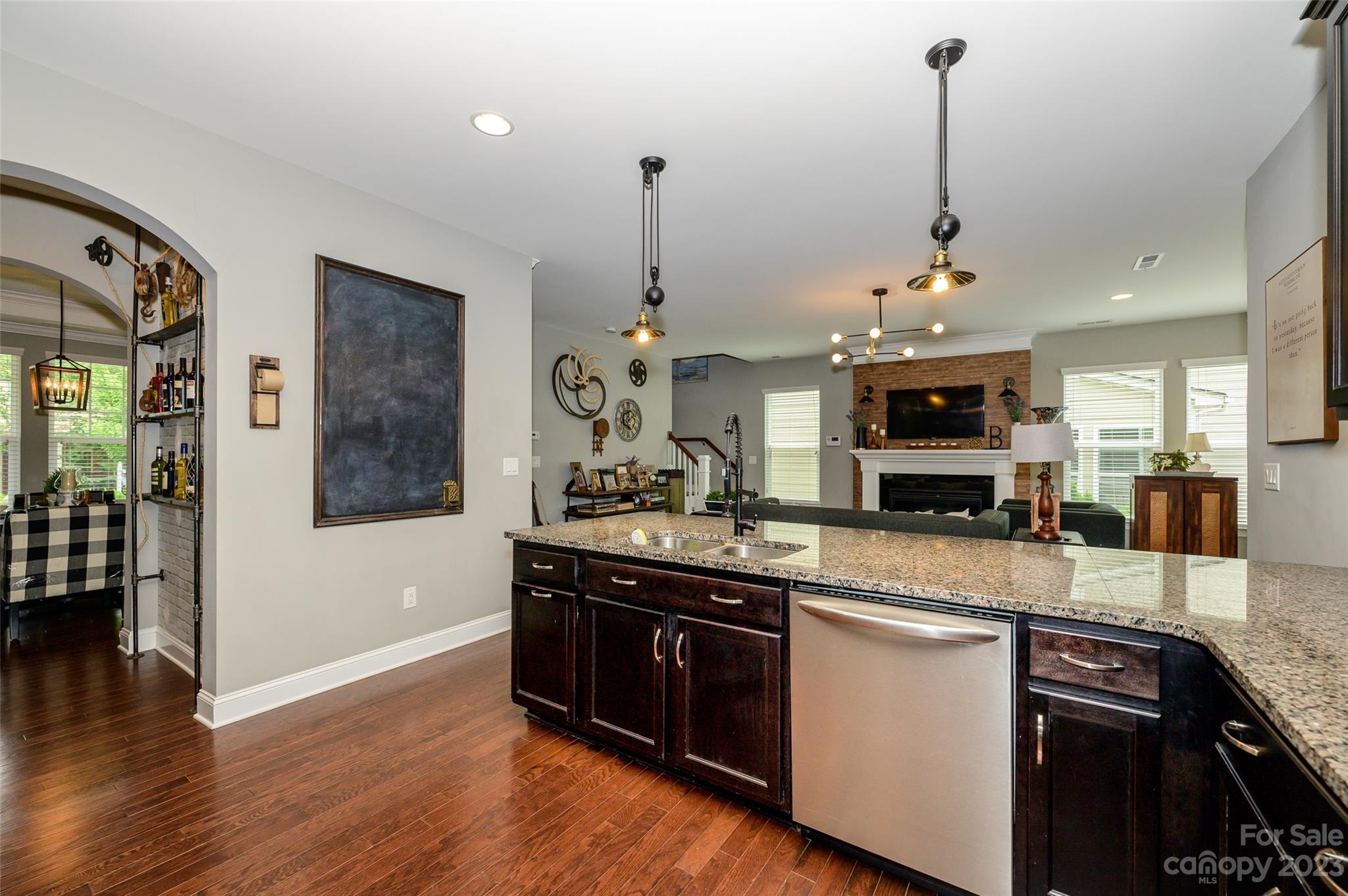 3317 Lucy Drive Monroe, NC 28110 - Photo 17 of 38 a kitchen with stainless steel appliances granite countertop a sink a stove and a wooden floor