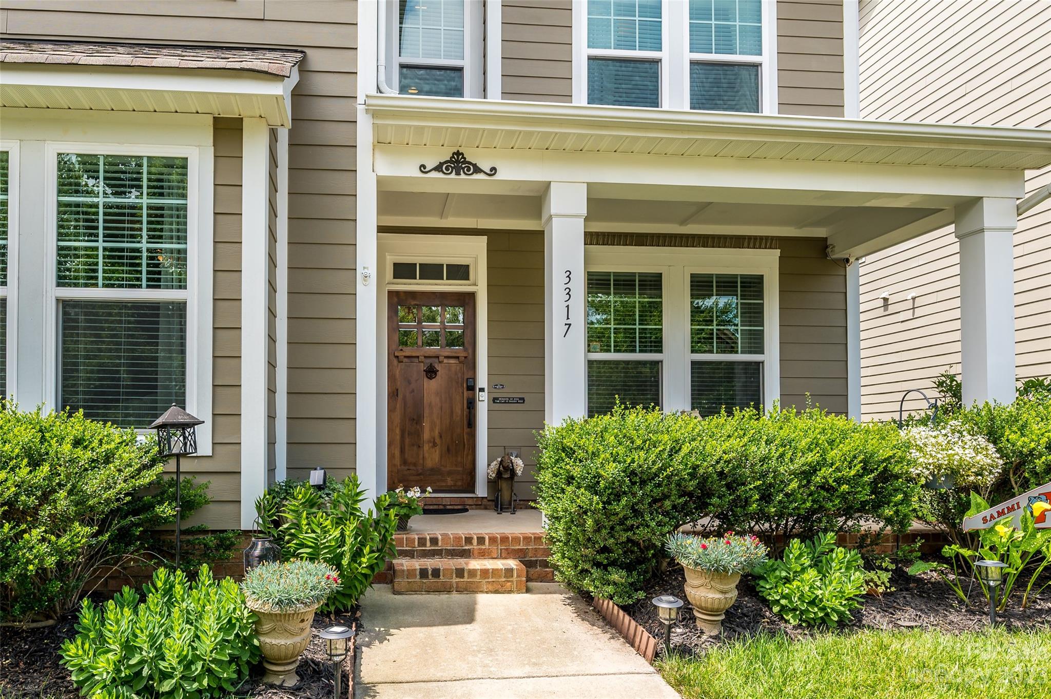 3317 Lucy Drive Monroe, NC 28110 - Photo 2 of 38 a house with potted plants in front of door