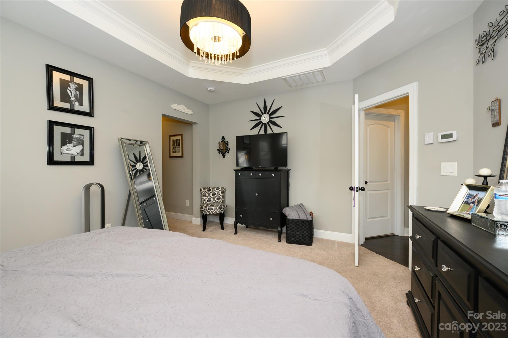 3317 Lucy Drive Monroe, NC 28110 - Photo 21 of 38 a bedroom with a bed and a chandelier