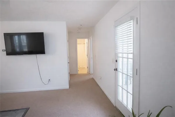 a view of a livingroom with wooden floor and windows