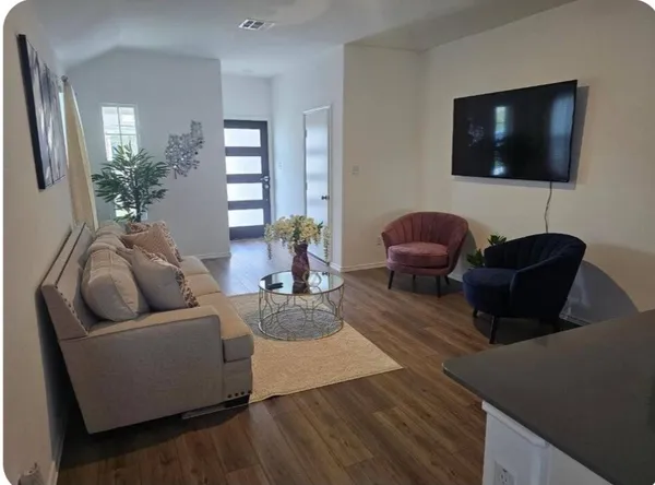 a living room with furniture and a flat screen tv