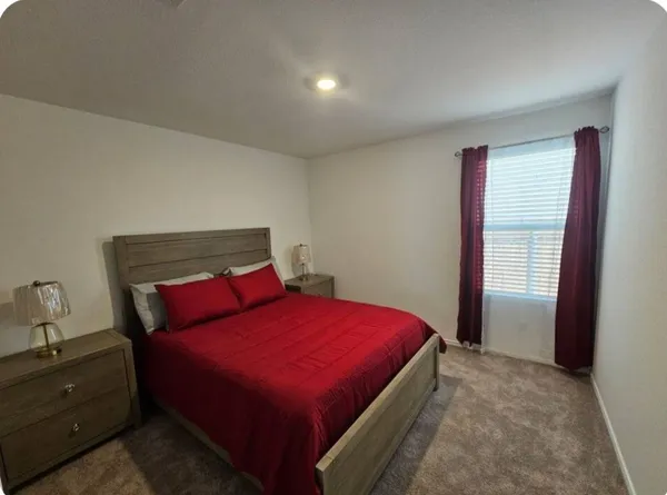 a bedroom with a bed and a window