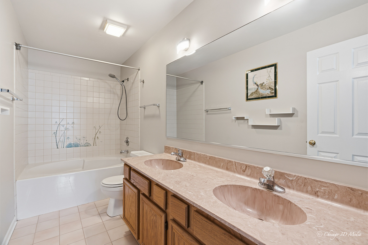 812 Old Checker Road Buffalo Grove, IL 60089 - Photo 14 of 26 a bathroom with a granite countertop sink mirror toilet and bathtub