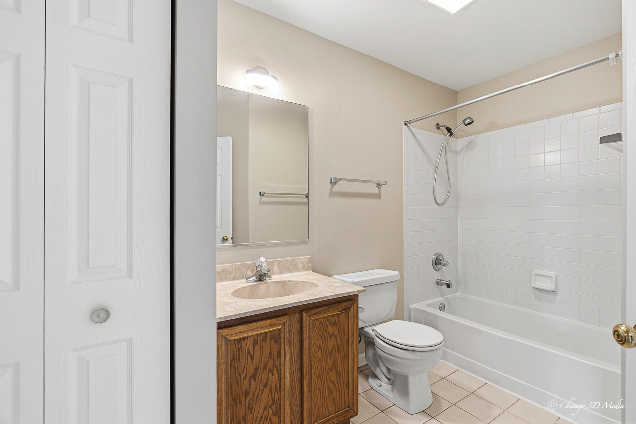 812 Old Checker Road Buffalo Grove, IL 60089 - Photo 16 of 26 a bathroom with a sink a toilet and shower