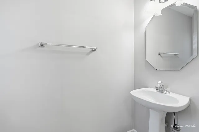 a bathroom with a sink a mirror and vanity