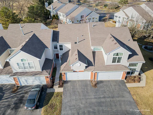 an aerial view of a house with a yard