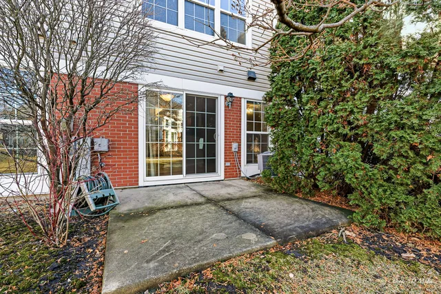 a front view of a house with a yard and potted plants
