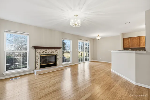 a view of an empty room with a fireplace and a window