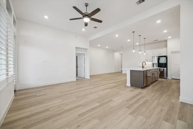 a view of a kitchen with a sink and a large window