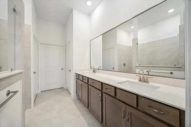 a bathroom with a double vanity sink and a mirror