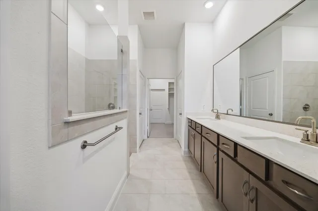a spacious bathroom with a double vanity sink mirror and double