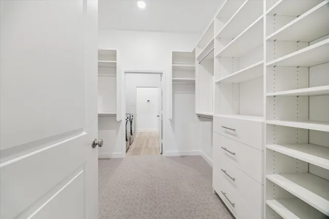 a utility room with cabinets washer and dryer