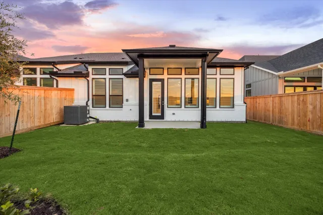a front view of a house with a garden and deck