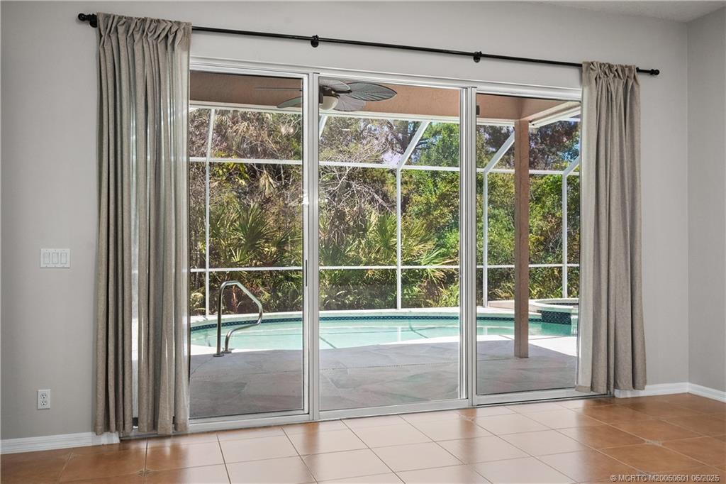7221 Southeast Seagate Lane Stuart, FL 34997 - Photo 16 of 51 a view of empty room with floor to ceiling window