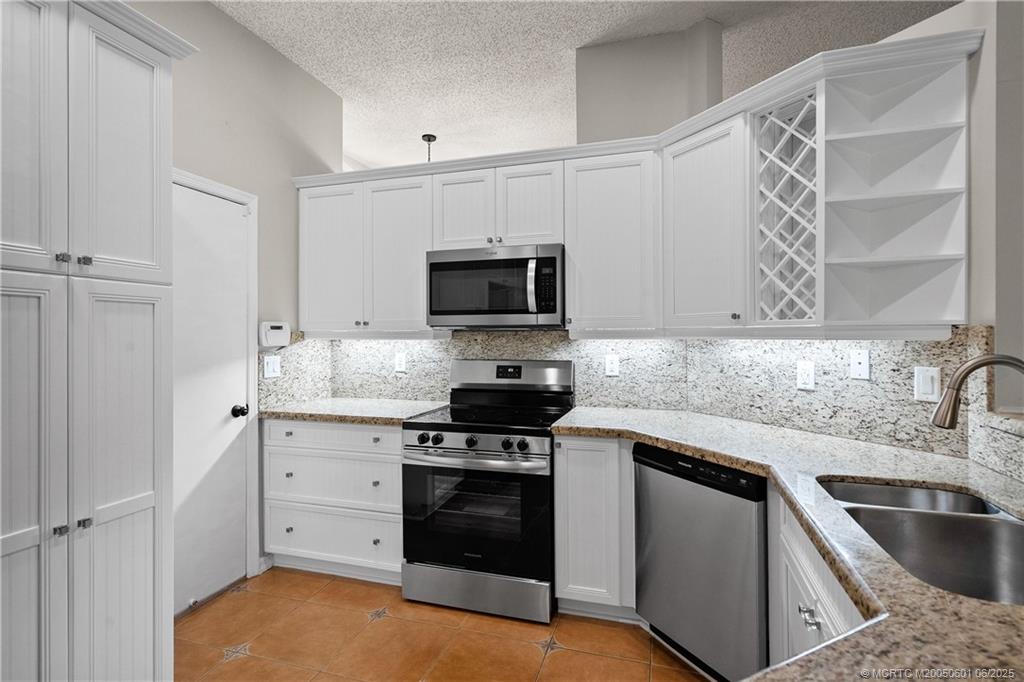 7221 Southeast Seagate Lane Stuart, FL 34997 - Photo 20 of 51 a kitchen with a sink stove and microwave