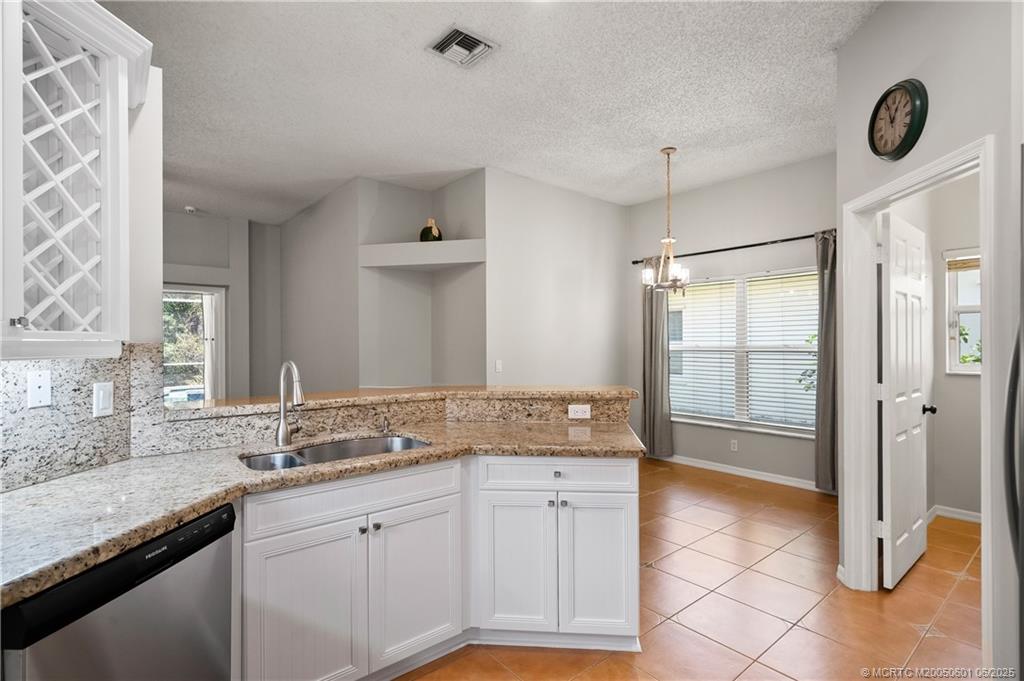 7221 Southeast Seagate Lane Stuart, FL 34997 - Photo 22 of 51 a spacious bathroom with a granite countertop sink and a mirror