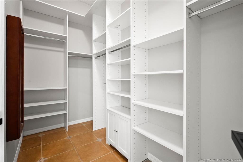 7221 Southeast Seagate Lane Stuart, FL 34997 - Photo 30 of 51 a view of walk in closet with empty racks