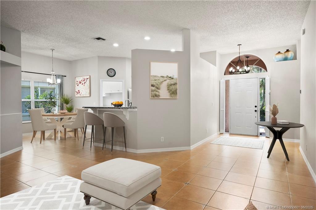7221 Southeast Seagate Lane Stuart, FL 34997 - Photo 3 of 51 a living room with furniture a window and a table
