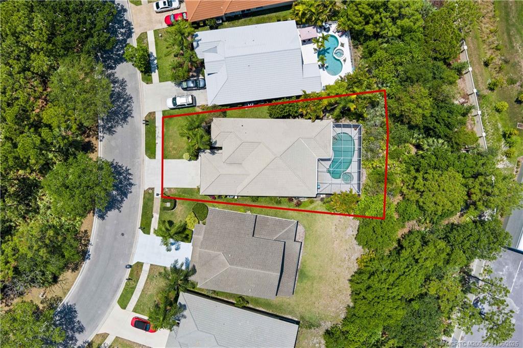 7221 Southeast Seagate Lane Stuart, FL 34997 - Photo 39 of 51 an aerial view of a house with a yard and tennis court