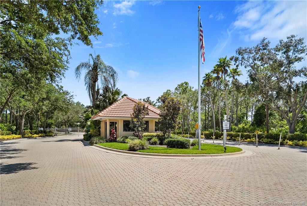 7221 Southeast Seagate Lane Stuart, FL 34997 - Photo 47 of 51 a view of a house with a yard and palm trees