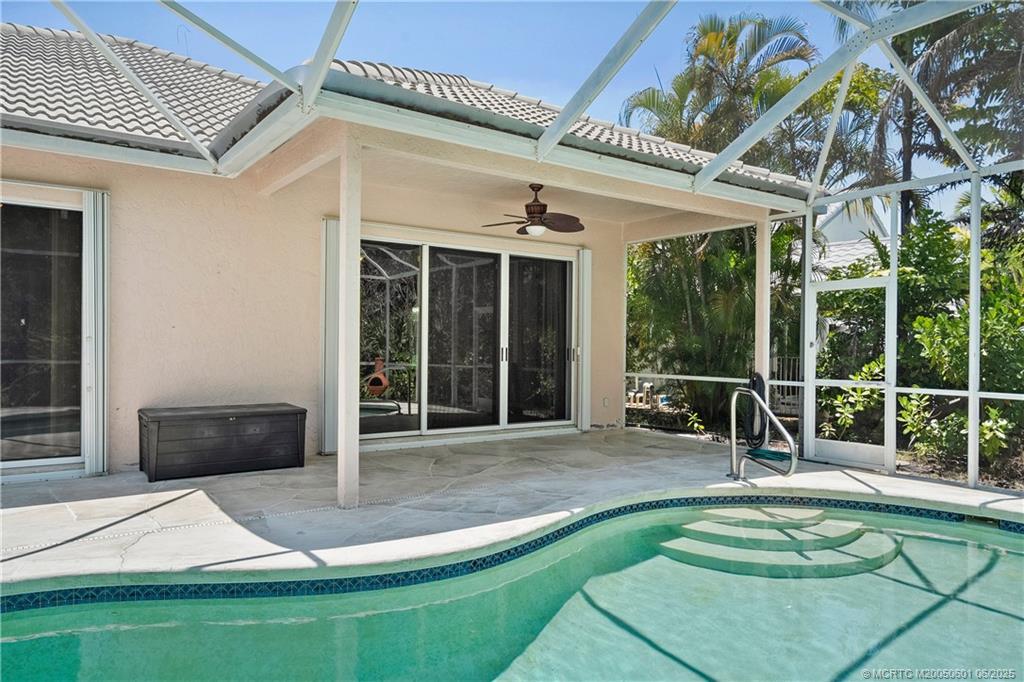 7221 Southeast Seagate Lane Stuart, FL 34997 - Photo 6 of 51 a view of a patio with table and chairs with wooden floor and fence