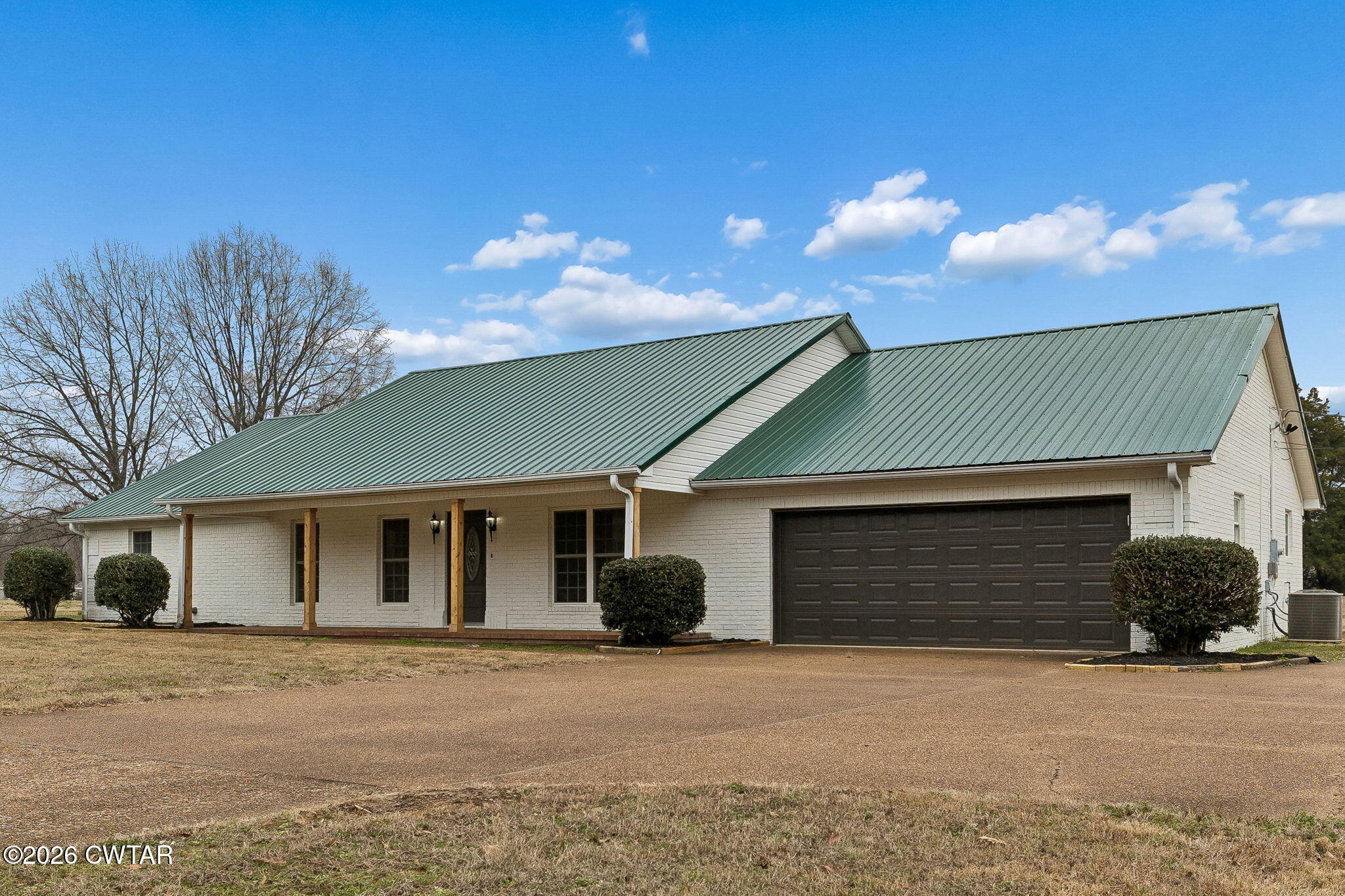 123 Walnut Hill Road Bells, TN 38006 - Photo 1 of 61 a front view of a house with a yard and garage