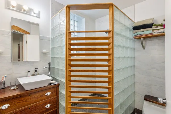 a kitchen that has a lot of cabinets a sink and appliances